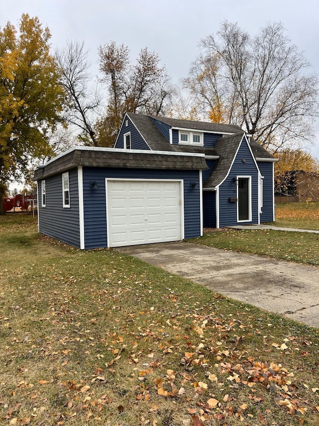 view of front of house featuring a front yard and a garage