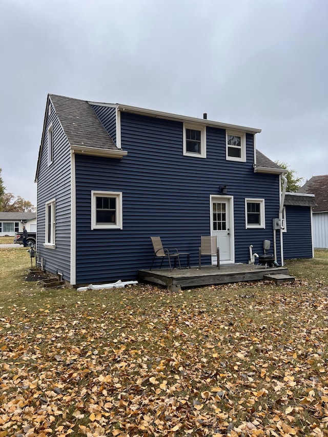 back of property with a wooden deck