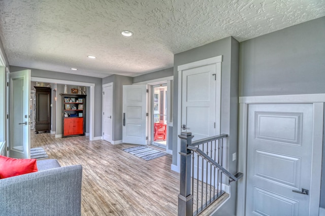 interior space featuring a textured ceiling and hardwood / wood-style flooring