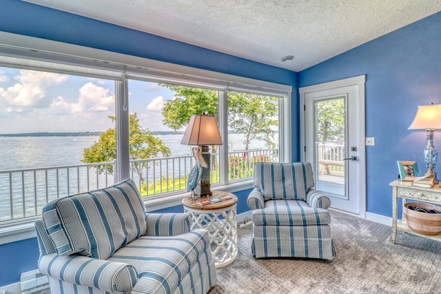 sunroom with a water view and vaulted ceiling