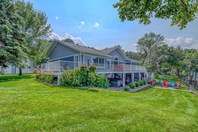 back of house with a deck and a yard