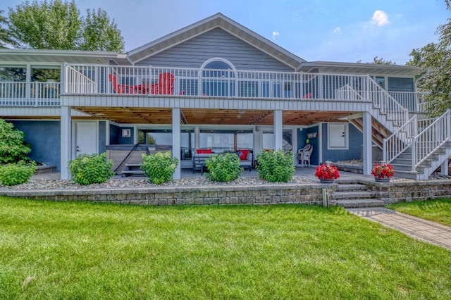 back of property featuring a patio area, a deck, and a lawn