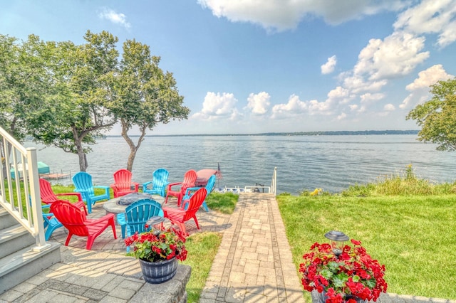 view of patio / terrace with a water view and a fire pit