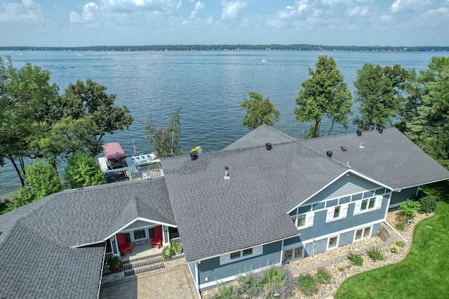 birds eye view of property with a water view