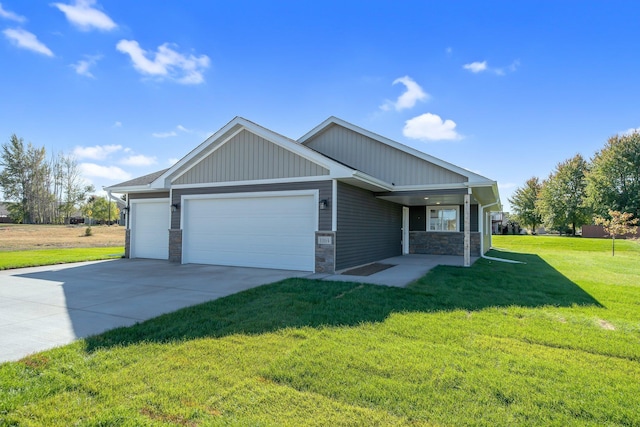 craftsman inspired home featuring a garage and a front lawn