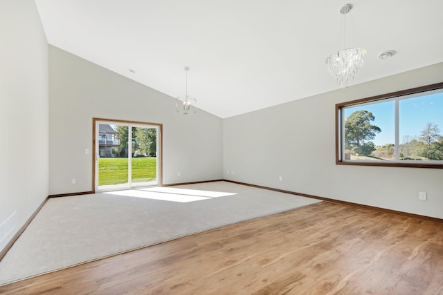 interior space with a chandelier, high vaulted ceiling, and light hardwood / wood-style floors