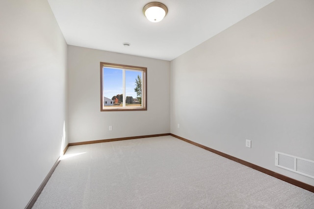 unfurnished room with light carpet and lofted ceiling