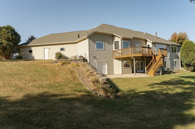 back of house featuring a wooden deck, a yard, and a patio area