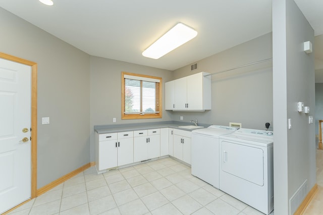 laundry room featuring cabinets, separate washer and dryer, sink, and light tile patterned floors