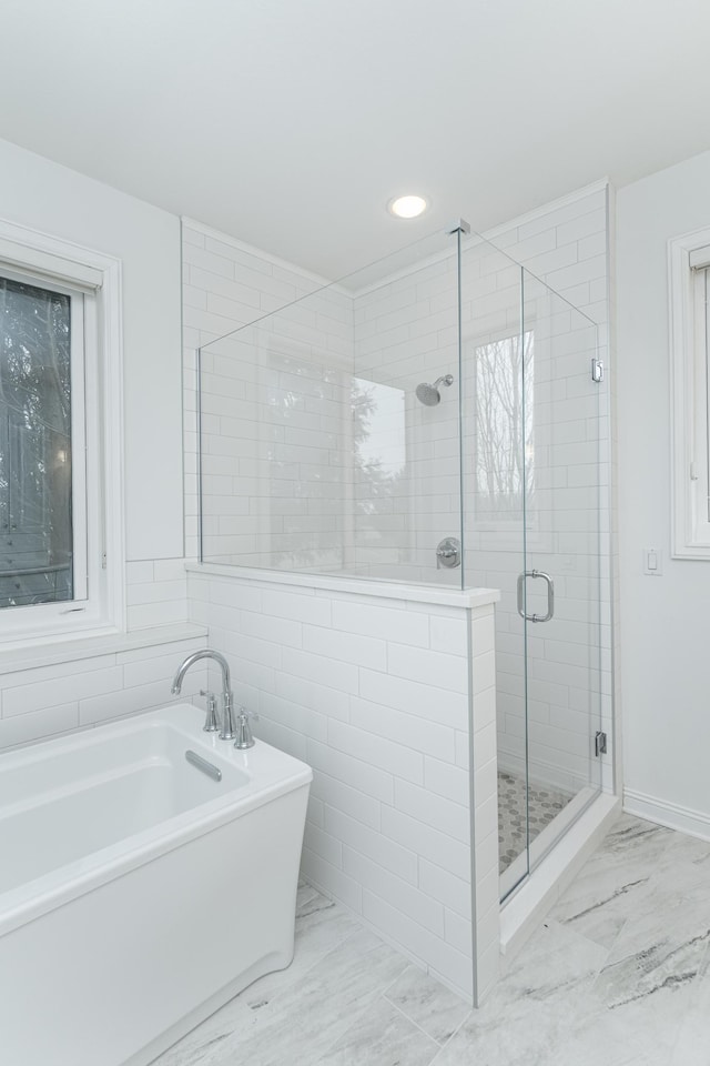 bathroom with separate shower and tub