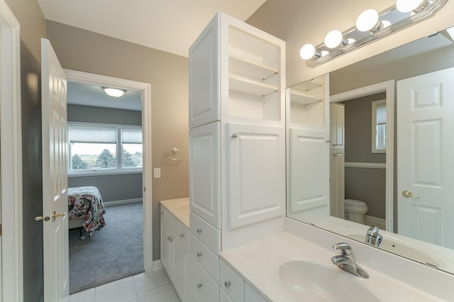 bathroom with vanity, toilet, and tile patterned flooring