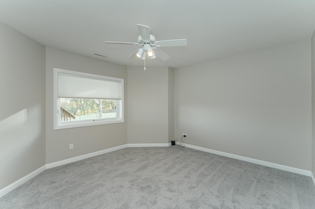 carpeted empty room featuring ceiling fan