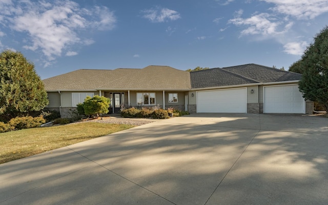 ranch-style house with a garage and a front yard