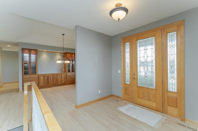 entryway with light hardwood / wood-style floors