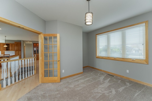 spare room with light colored carpet