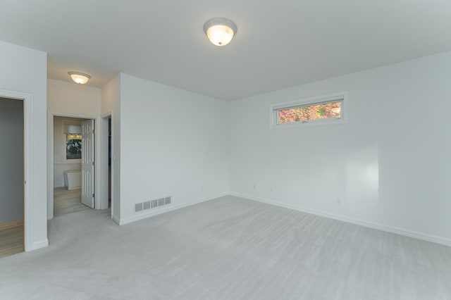 spare room with light colored carpet