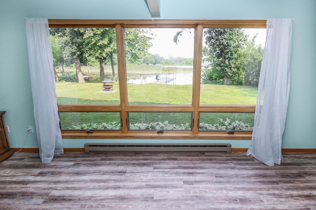 doorway to outside with baseboard heating, a water view, and a wealth of natural light