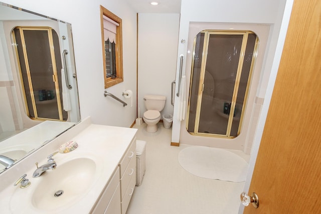 bathroom with vanity, toilet, and an enclosed shower