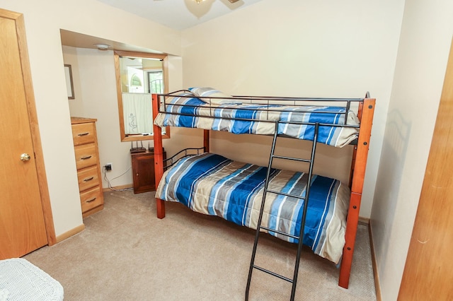 bedroom featuring light carpet