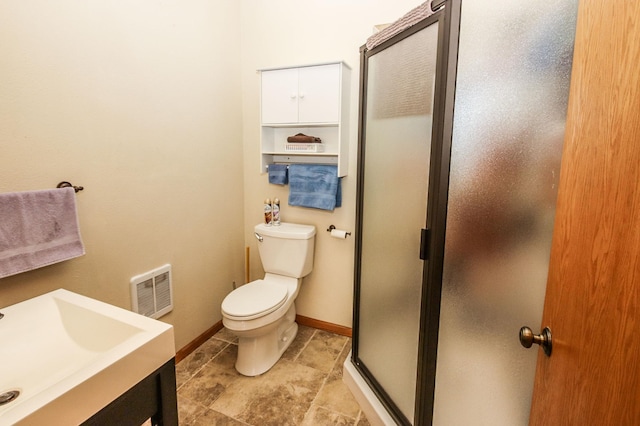 bathroom with vanity, toilet, and an enclosed shower