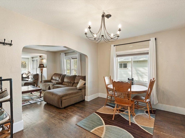 dining room featuring dark hardwood / wood-style floors, a textured ceiling, and a wealth of natural light