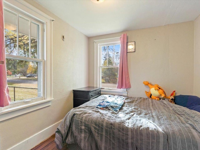 bedroom with hardwood / wood-style flooring