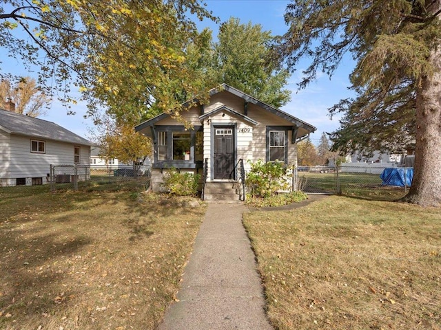 bungalow-style home featuring a front yard