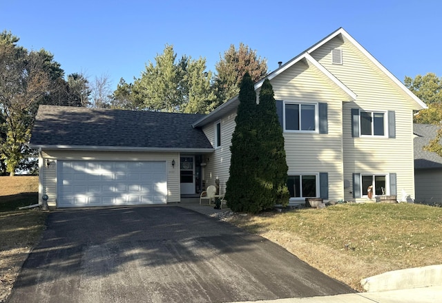 view of front of property featuring a garage and a front lawn