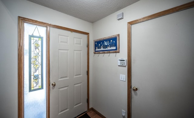 entrance foyer featuring a textured ceiling