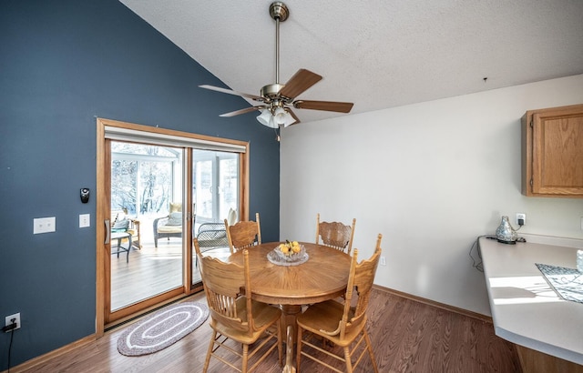 dining room featuring a textured ceiling, dark hardwood / wood-style floors, vaulted ceiling, and ceiling fan