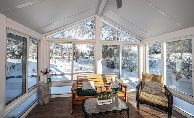 sunroom featuring vaulted ceiling with beams and a healthy amount of sunlight