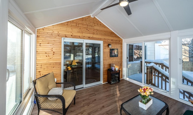 sunroom featuring lofted ceiling with beams and ceiling fan