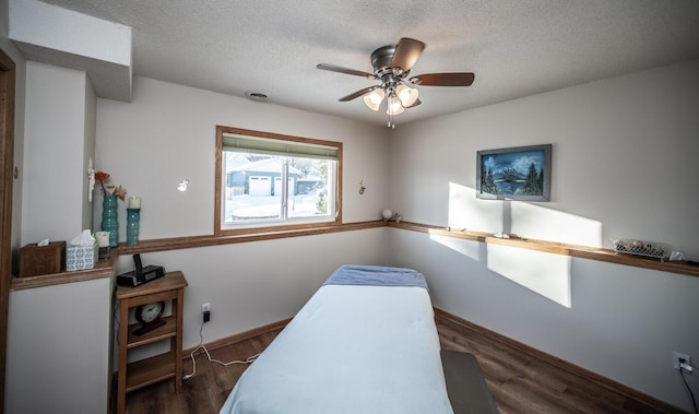 office space with ceiling fan, dark hardwood / wood-style flooring, and a textured ceiling