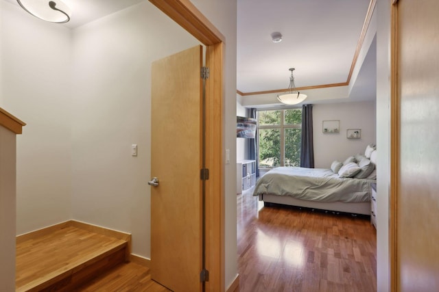 bedroom featuring ornamental molding and hardwood / wood-style floors