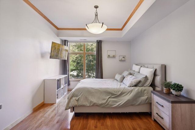 bedroom featuring ornamental molding and wood-type flooring