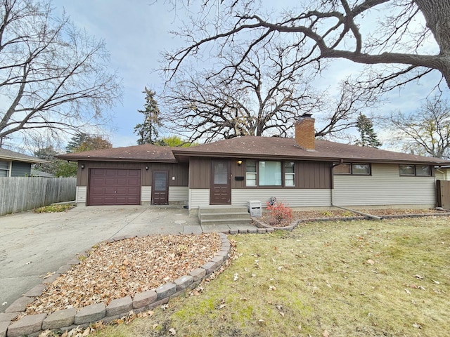 single story home with a garage and a front yard