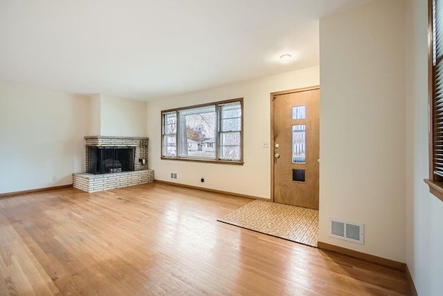 unfurnished living room with light hardwood / wood-style floors and a fireplace