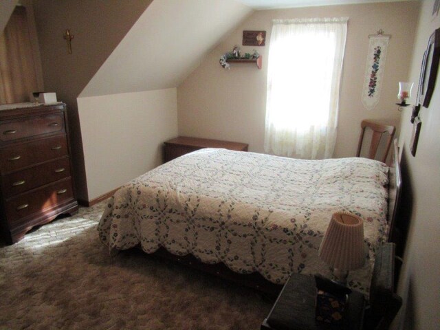 carpeted bedroom with vaulted ceiling