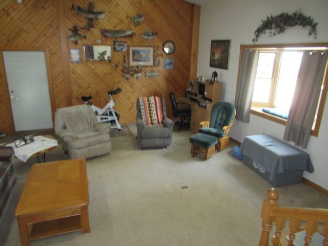 carpeted living room with wood walls