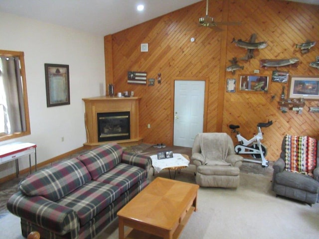 living room with wooden walls, a high ceiling, and ceiling fan