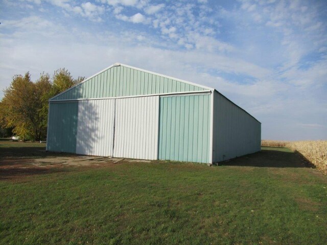 view of outdoor structure with a lawn