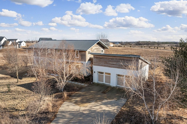 view of outdoor structure featuring driveway and an attached garage