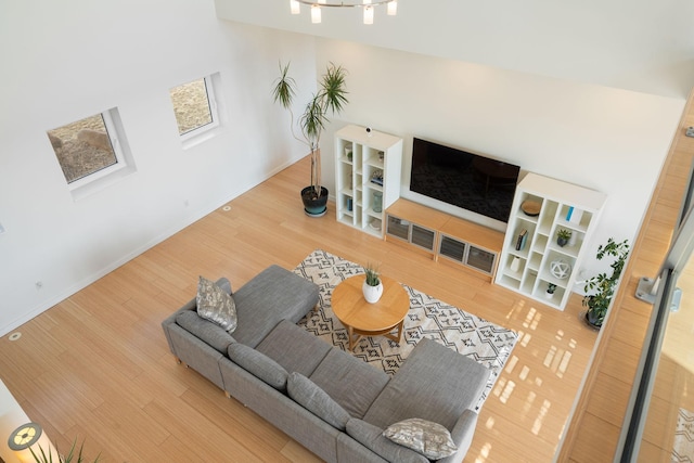 living area featuring baseboards and wood finished floors