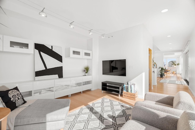 living room with recessed lighting, rail lighting, and wood finished floors