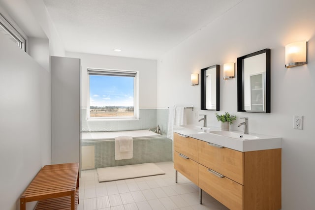 full bath with double vanity, a sink, and tile patterned floors