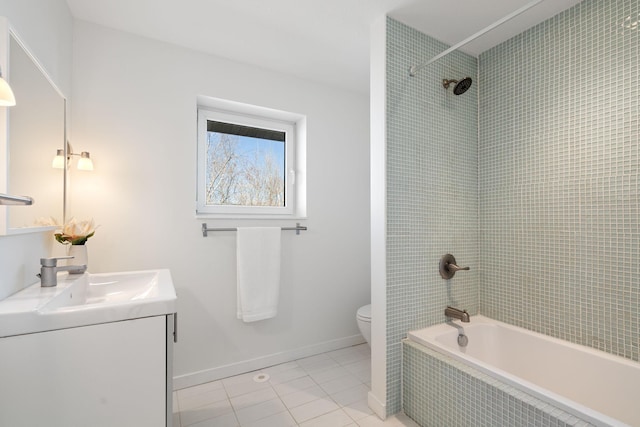 full bath with baseboards, toilet, tiled shower / bath combo, tile patterned flooring, and vanity