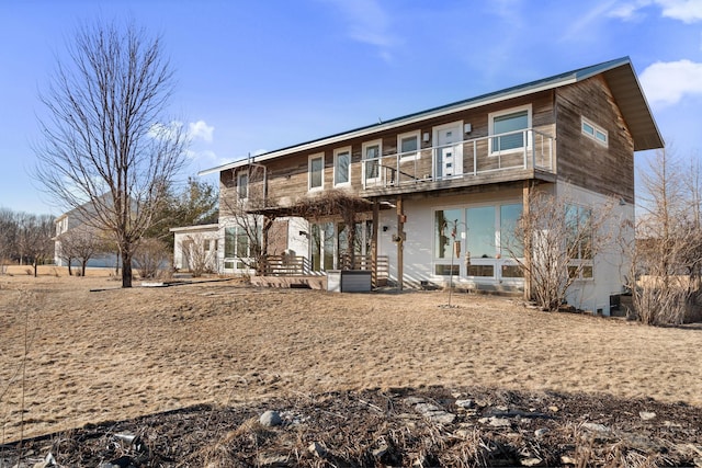 rear view of house featuring a balcony