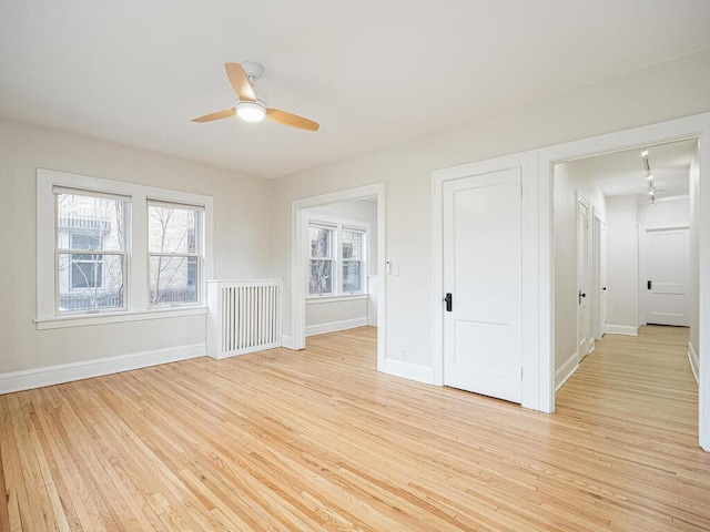 unfurnished room featuring ceiling fan and light hardwood / wood-style flooring