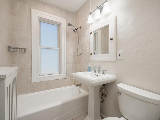 bathroom featuring toilet and tiled shower / bath combo