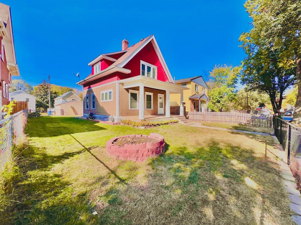 rear view of house with a yard